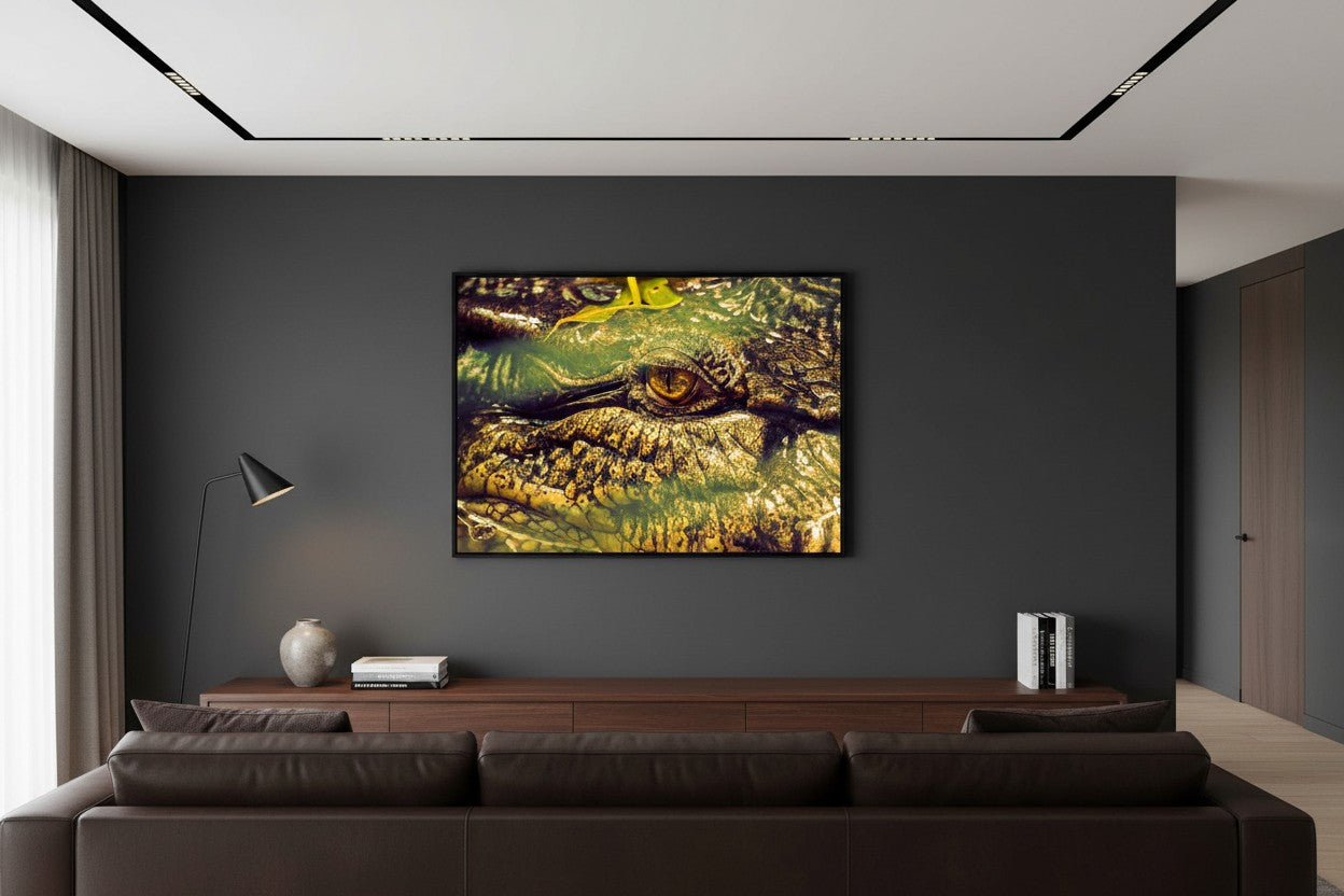 Ancient Watcher tropical wildlife fine art print in a thin black frame on a dark charcoal feature wall in a bold sophisticated living room with dark timber and leather — unframed wall art