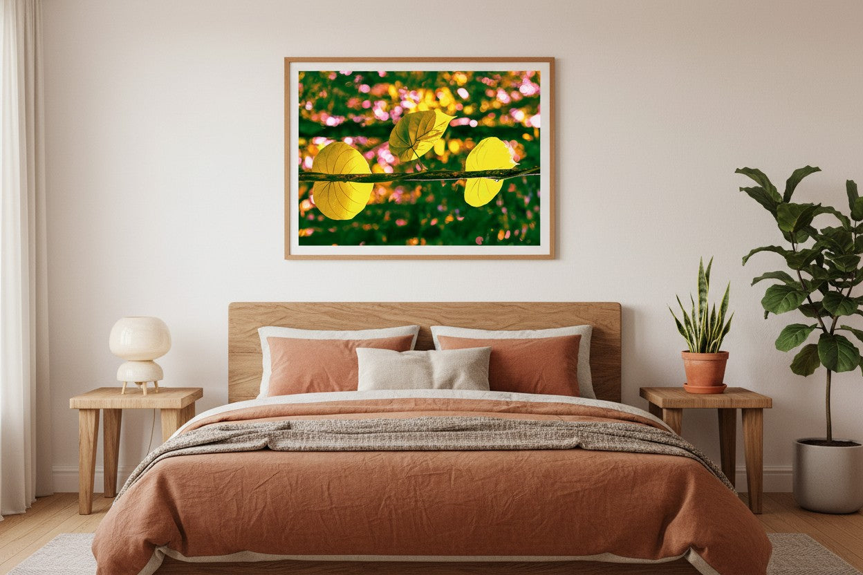 Daintree Vine abstract botanical fine art print in a thin timber frame above a bed in a warm nature-inspired bedroom with earthy linen and indoor plants — unframed wall art