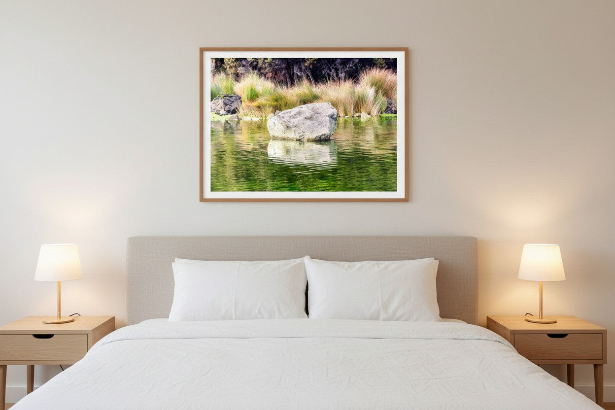 Kōhatu fine art print above a bed in a calm minimalist bedroom with white linen and timber — unframed nature photography