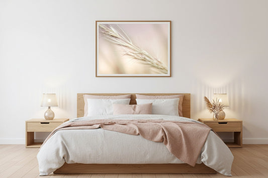 Soft Stillness fine art print in a thin timber frame above a bed in a serene minimal bedroom with white and blush linen and dried flowers — unframed botanical wall art