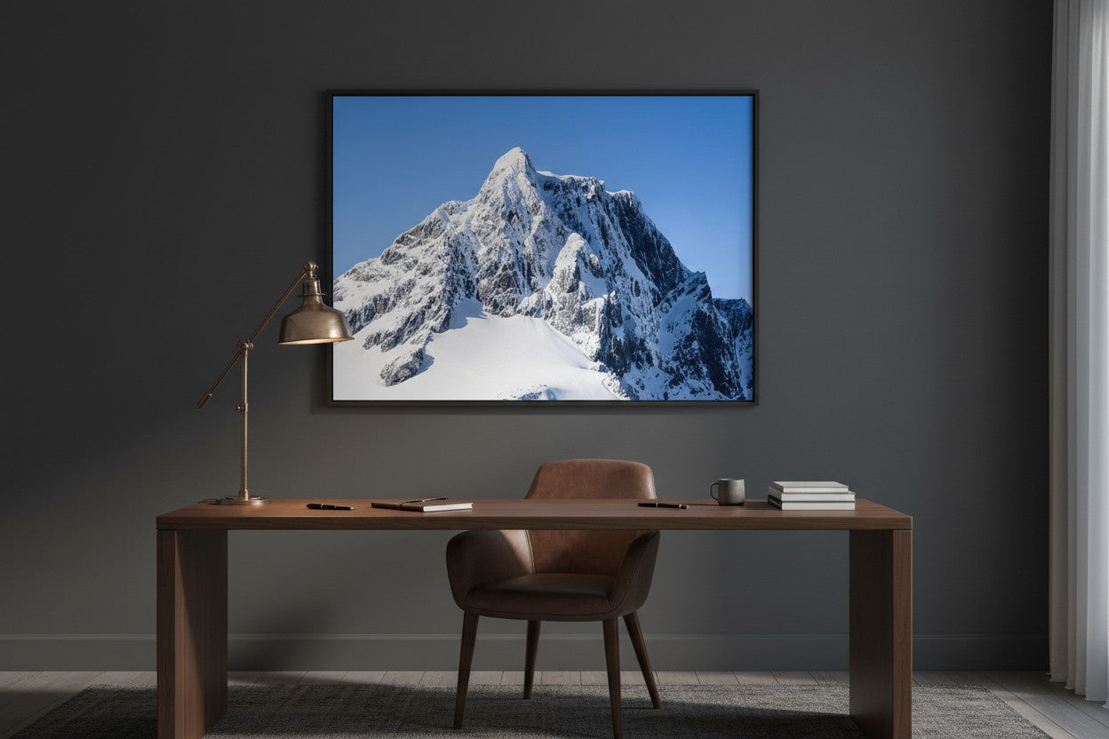 The Limit Mount Pembroke fine art print in a dark moody home office — unframed statement wall art, Fiordland New Zealand