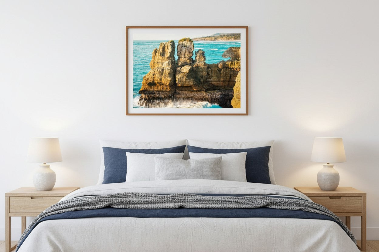 What Can You Sea fine art print in a thin timber frame above a bed in a calm coastal bedroom with white and navy linen — unframed coastal wall art